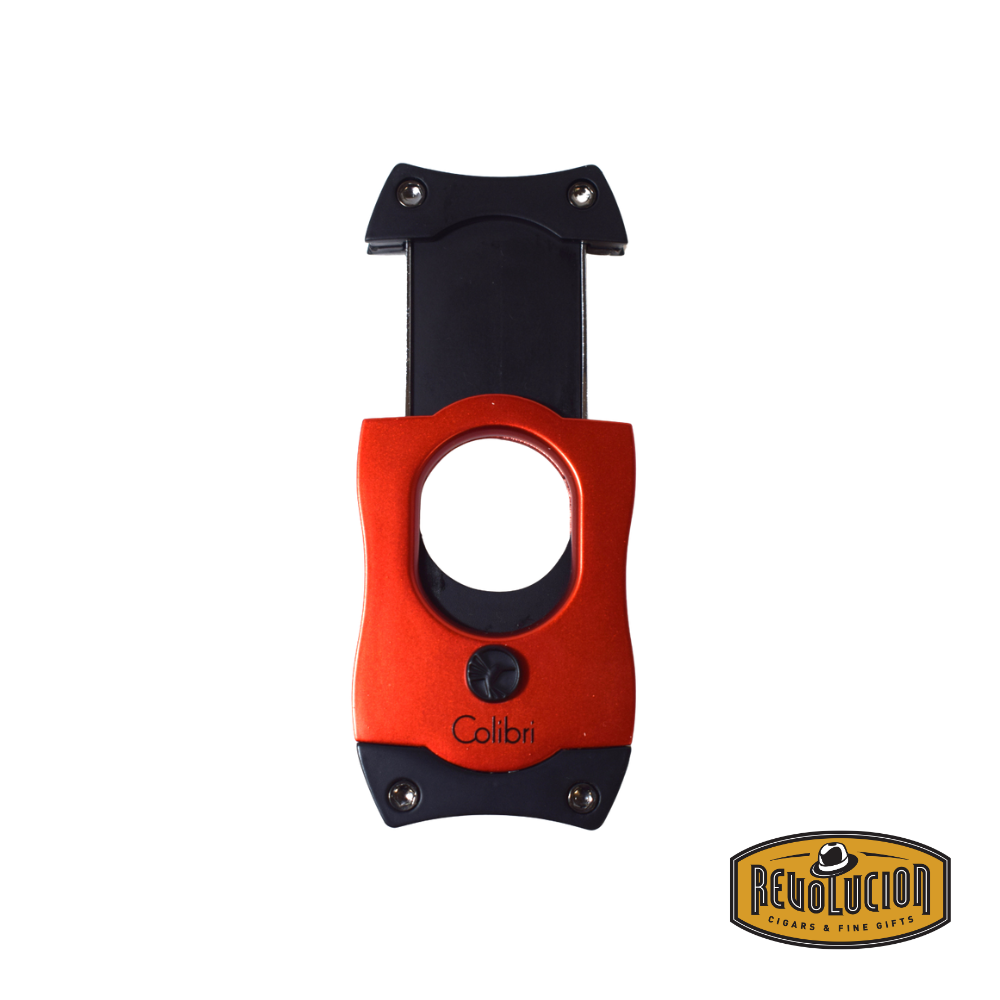 The Colibri S-Cut cigar cutter in red and black, showcasing its sharp stainless-steel blade in an open position, ready for a precise cut.