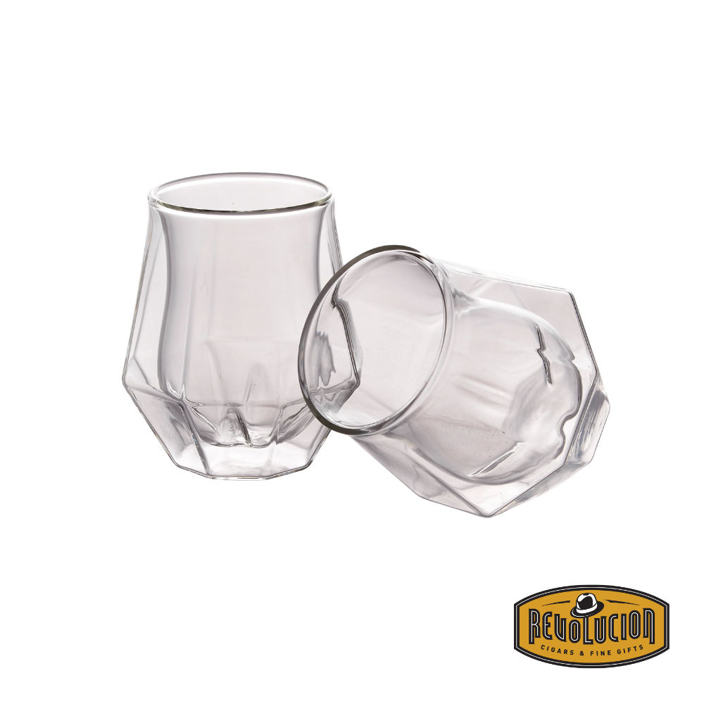 A set of two Diamond Double Wall Whisky Glasses, one standing upright and the other resting on its side, showcasing their unique faceted design and modern double-wall construction.