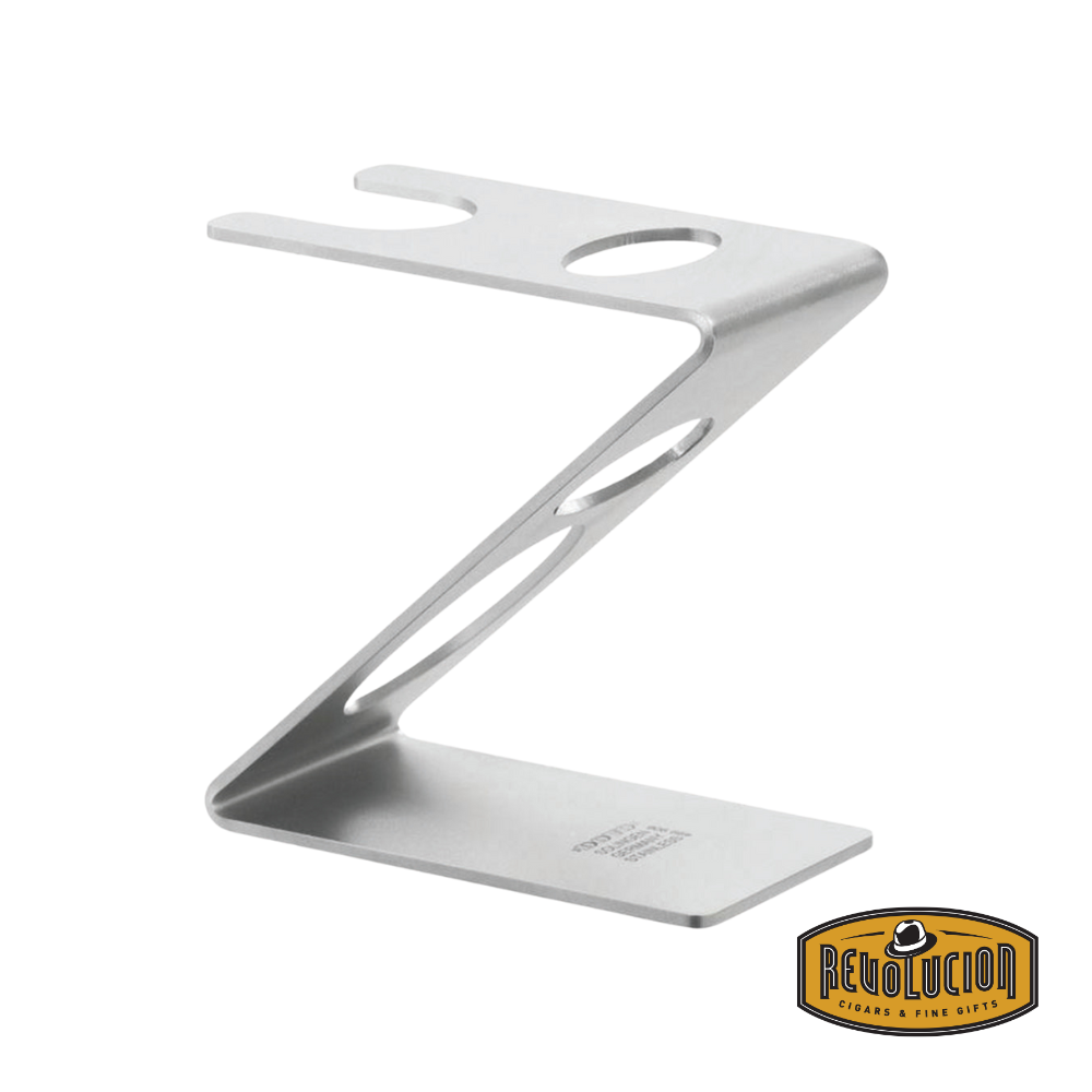 Dovo Stand holding a brush and straight razor – elegant chrome-finished grooming stand displaying a shaving brush and straight razor in perfect harmony.