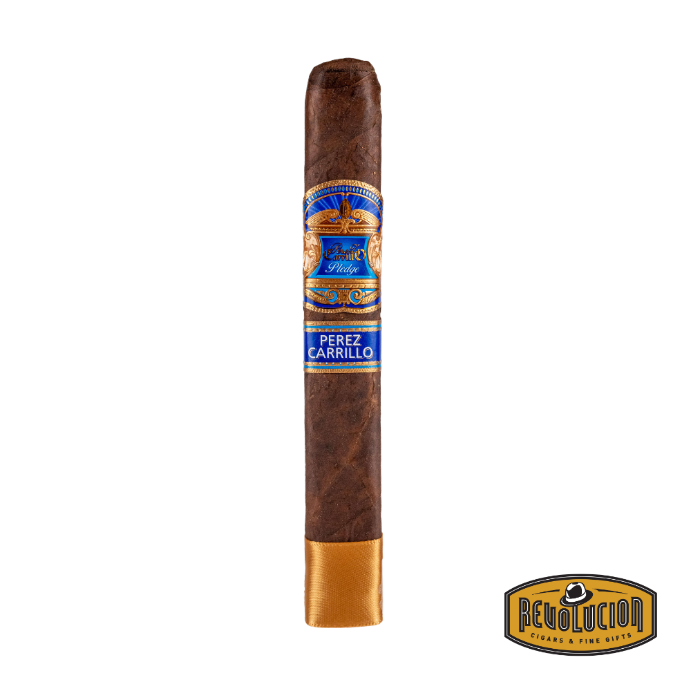 EP Carrillo Pledge Sojourn Full Strength Dominican Cigar resting on a wooden surface with a white background, showcasing its dark wrapper and elegant band design.