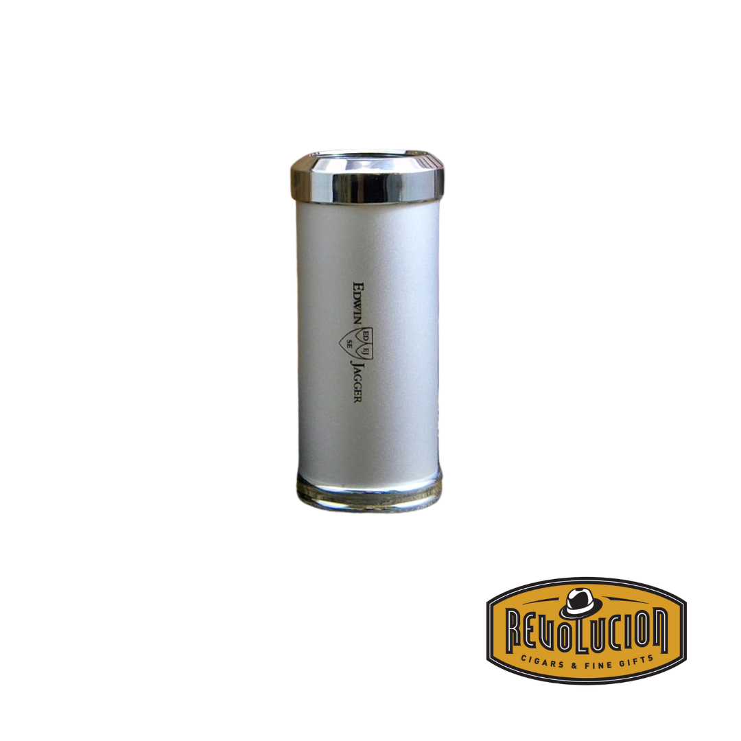 A closed Edwin Jagger travel shaving brush in chrome silver finish, with a sleek cylindrical design and a polished metal top and bottom. The Edwin Jagger logo is engraved on the side. The Revolucion Cigars & Fine Gifts logo is displayed at the bottom right.