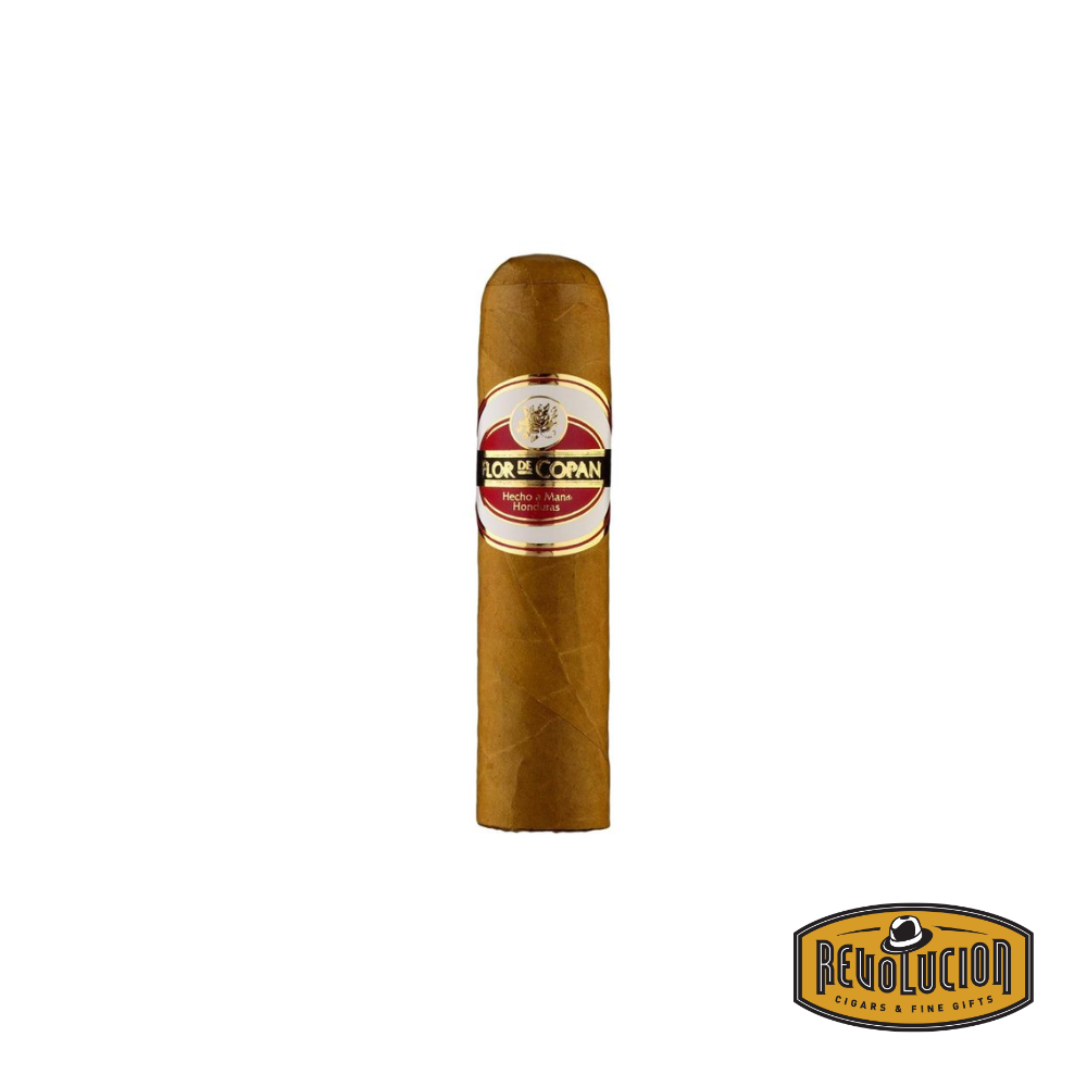 Flor de Copan Short Magnum Mild-Medium Strength Honduran Cigars featuring a smooth, light brown wrapper and elegant band, displayed on a cedar surface.