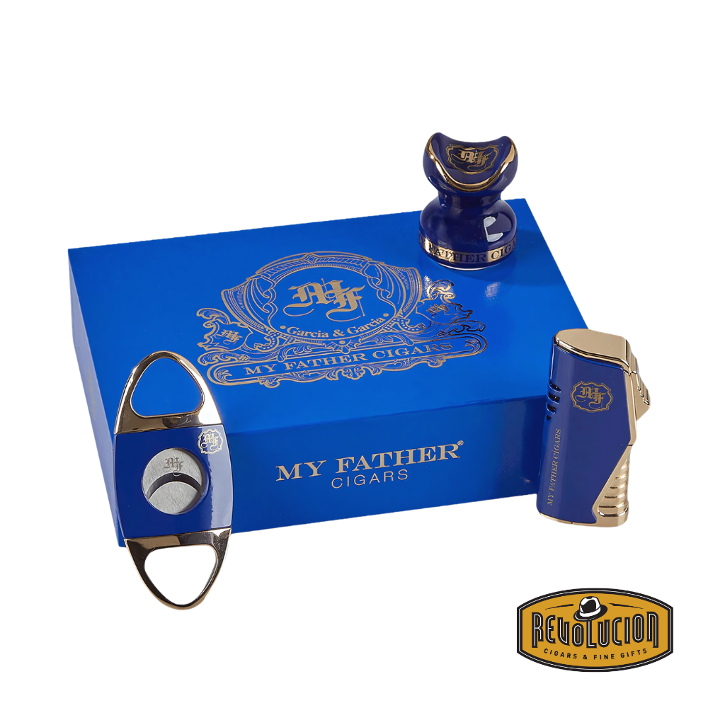 My Father 3-Piece Gift Set in Blue, featuring a cigar cutter, triple-torch lighter, and ceramic cigar holder, all elegantly presented in a luxurious blue box with gold accents, displayed with the Revolucion Cigars &amp; Fine Gifts logo.