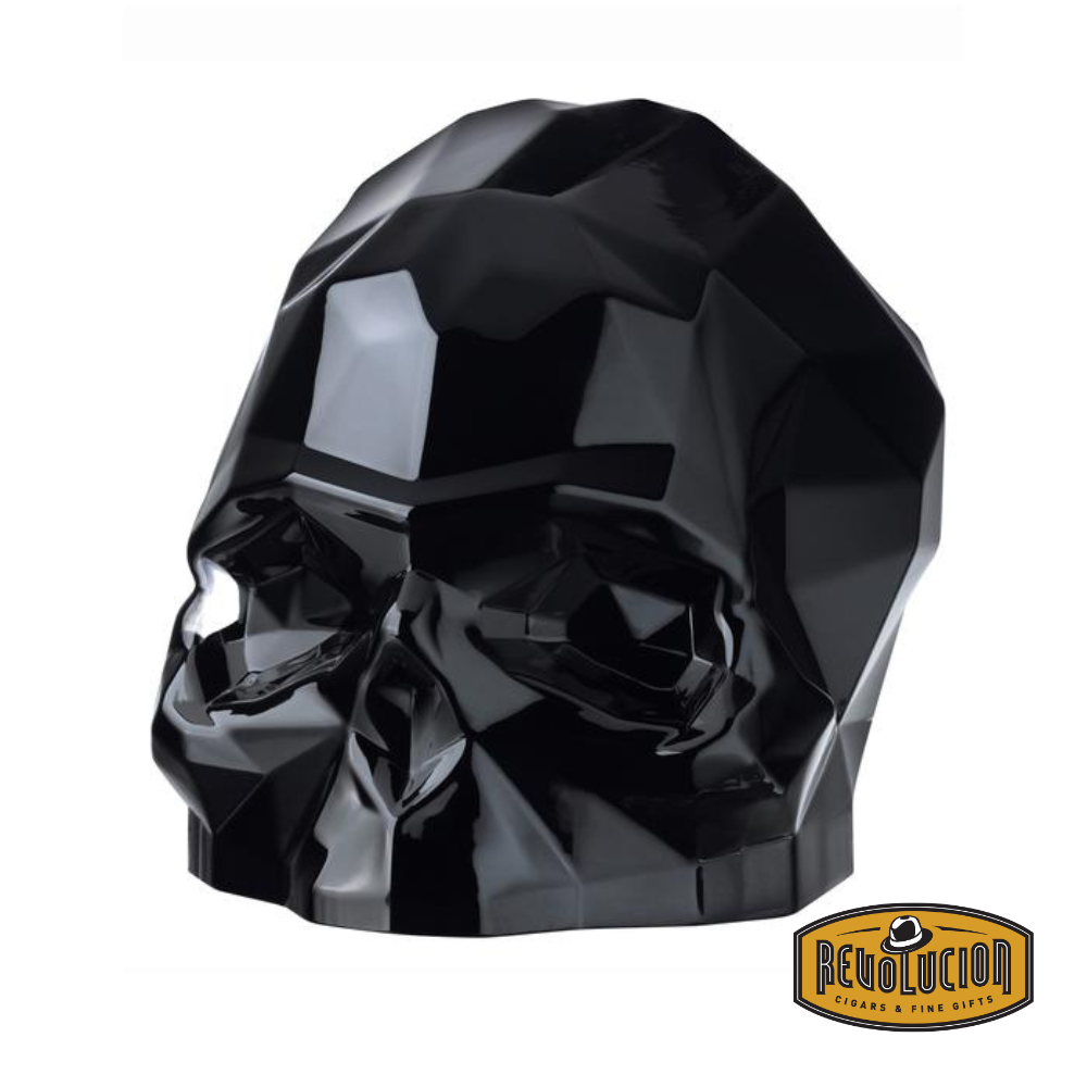 Sleek, faceted black skull sculpture with a modern geometric design, embodying the “memento mori” concept. Includes the Revolucion Cigars &amp; Fine Gifts logo