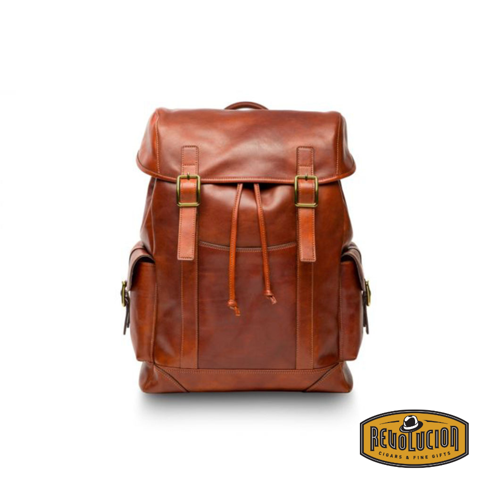 Premium leather backpack in a rich cognac tone, featuring brass buckle accents, drawstring closure, and multiple pockets for a sophisticated yet functional design. Includes the Revolucion Cigars &amp; Fine Gifts logo