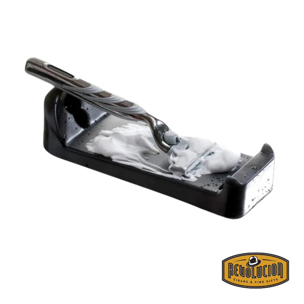 Razor being cleaned on the Razor Pit Sharpener to restore blade sharpness.