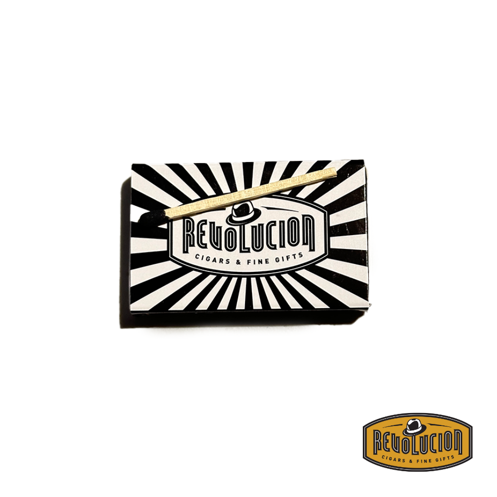 A box of Revolucion Premium Wooden Matches with a single match placed outside, ready for use.