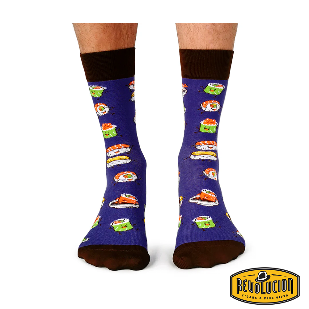 Front view of purple socks featuring colorful sushi graphics, with dark brown cuffs, toes, and heels. The socks are branded with the Revolucion Cigars &amp; Fine Gifts logo