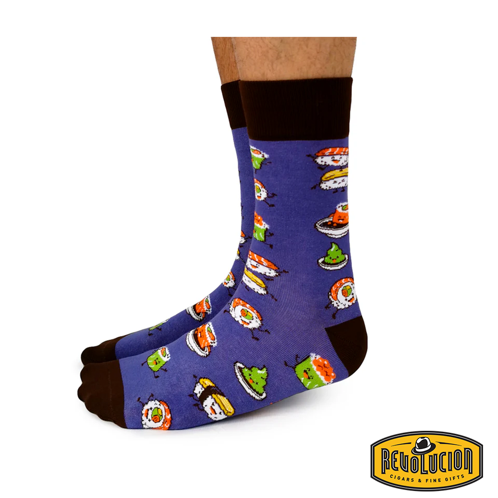 Front view of purple socks featuring colorful sushi graphics, with dark brown cuffs, toes, and heels. The socks are branded with the Revolucion Cigars & Fine Gifts logo