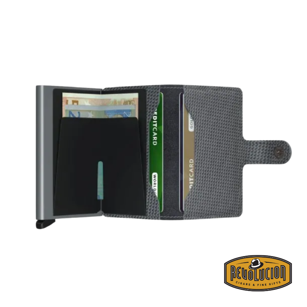 The Secrid Miniwallet in Carbon Cool Grey, fully opened, showcasing multiple card slots, a bill compartment, and a smooth grey interior.