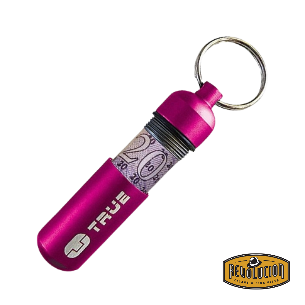 True Utility CashStash Pink keychain capsule slightly opened with a bill inside, showcasing compact emergency cash storage.