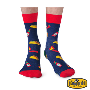 Front view of blue socks featuring taco, hot sauce bottle, and chili pepper graphics. Socks have red cuffs and toes, branded with the Revolucion Cigars & Fine Gifts logo
