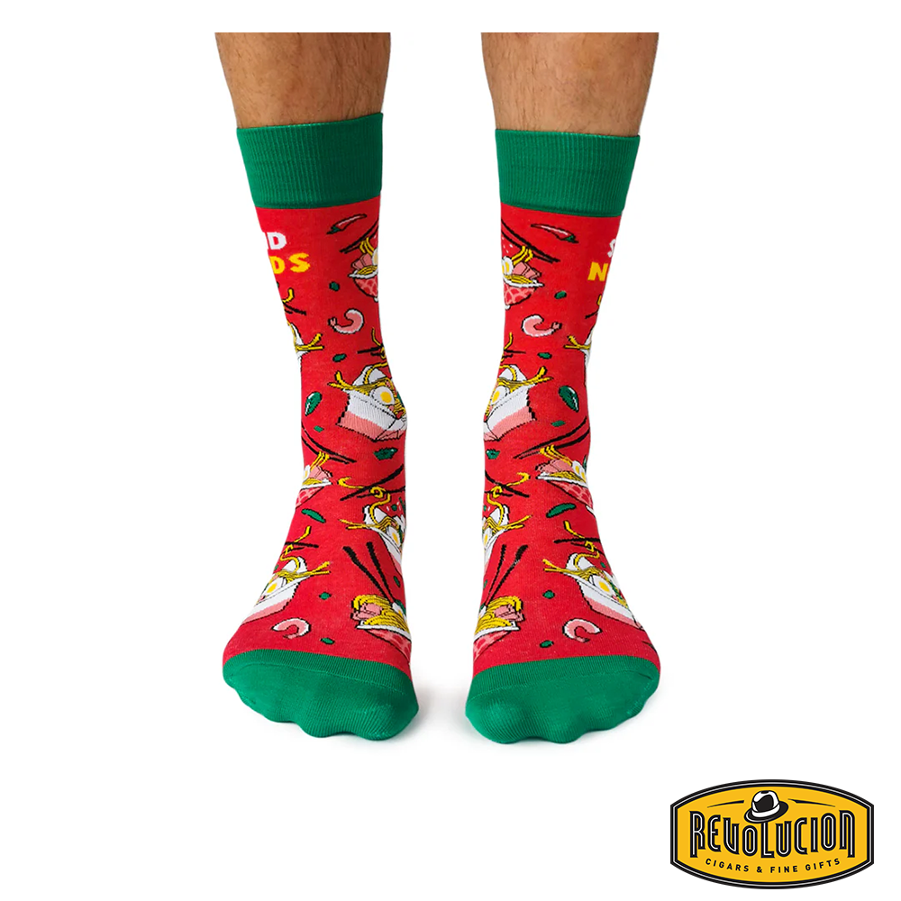 Front view of red socks featuring playful noodle graphics with green cuffs and toes. The socks are branded with the Revolucion Cigars &amp; Fine Gifts logo