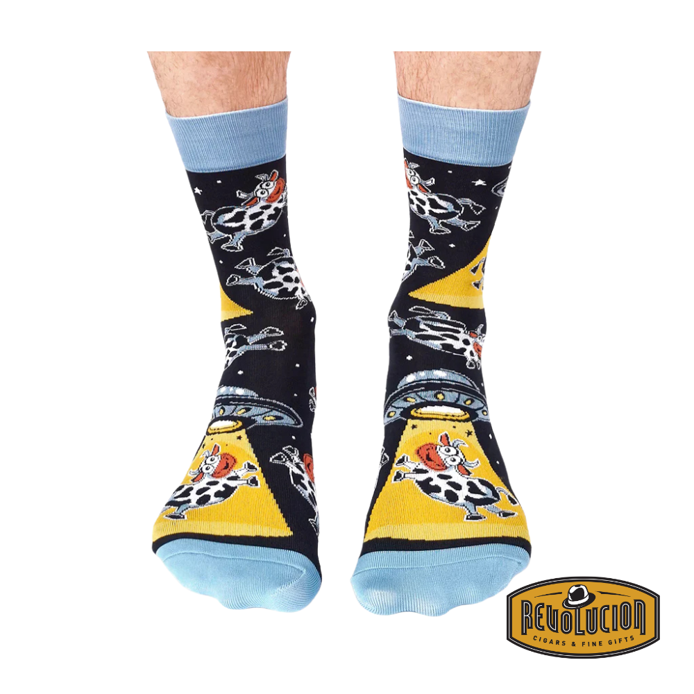 Front view of Uptown Cosmic Cows calf-length cotton unisex socks featuring a whimsical space-themed cow design on a soft and breathable fabric.