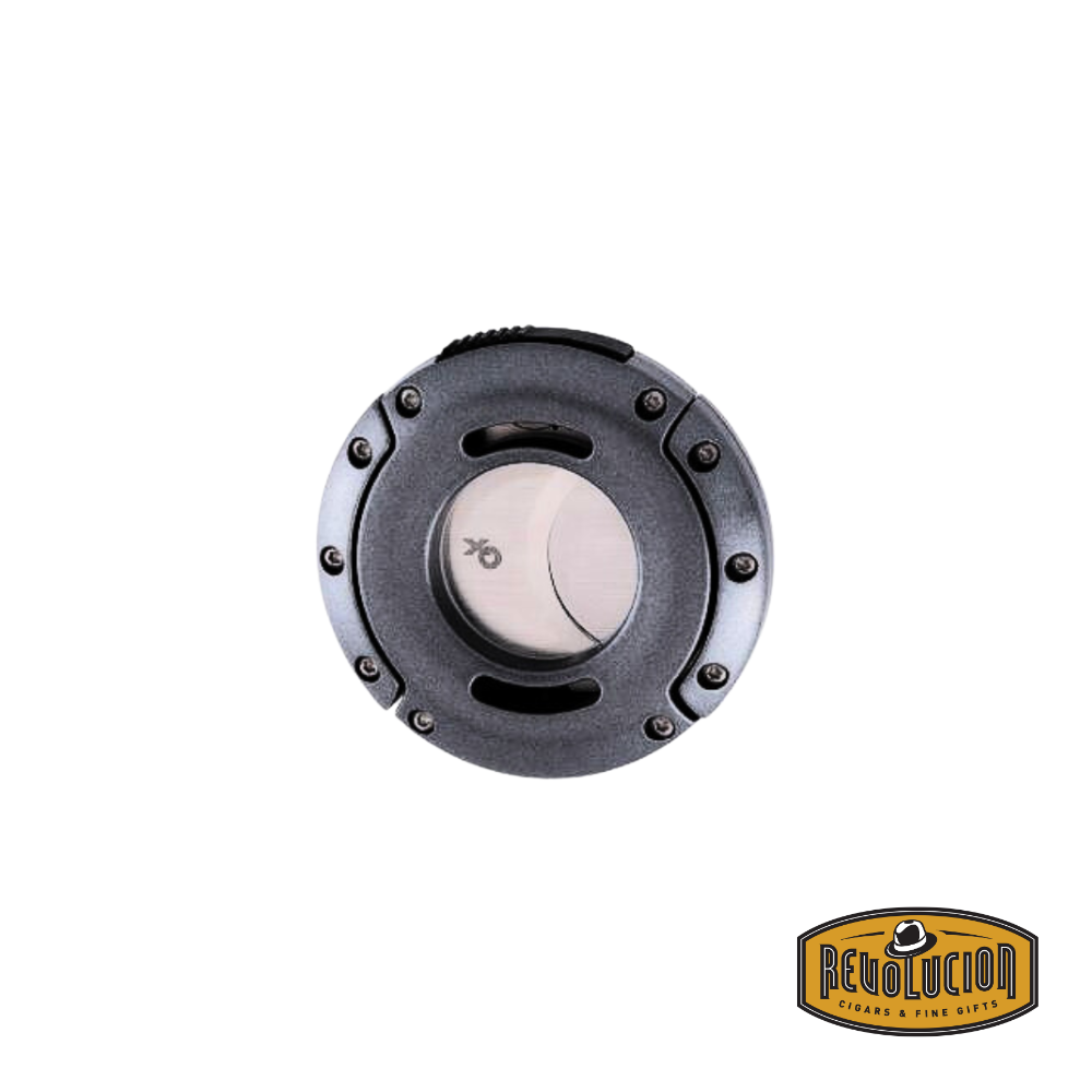 Xikar XO cigar cutter in gunmetal, closed, highlighting its compact round shape and durable construction.