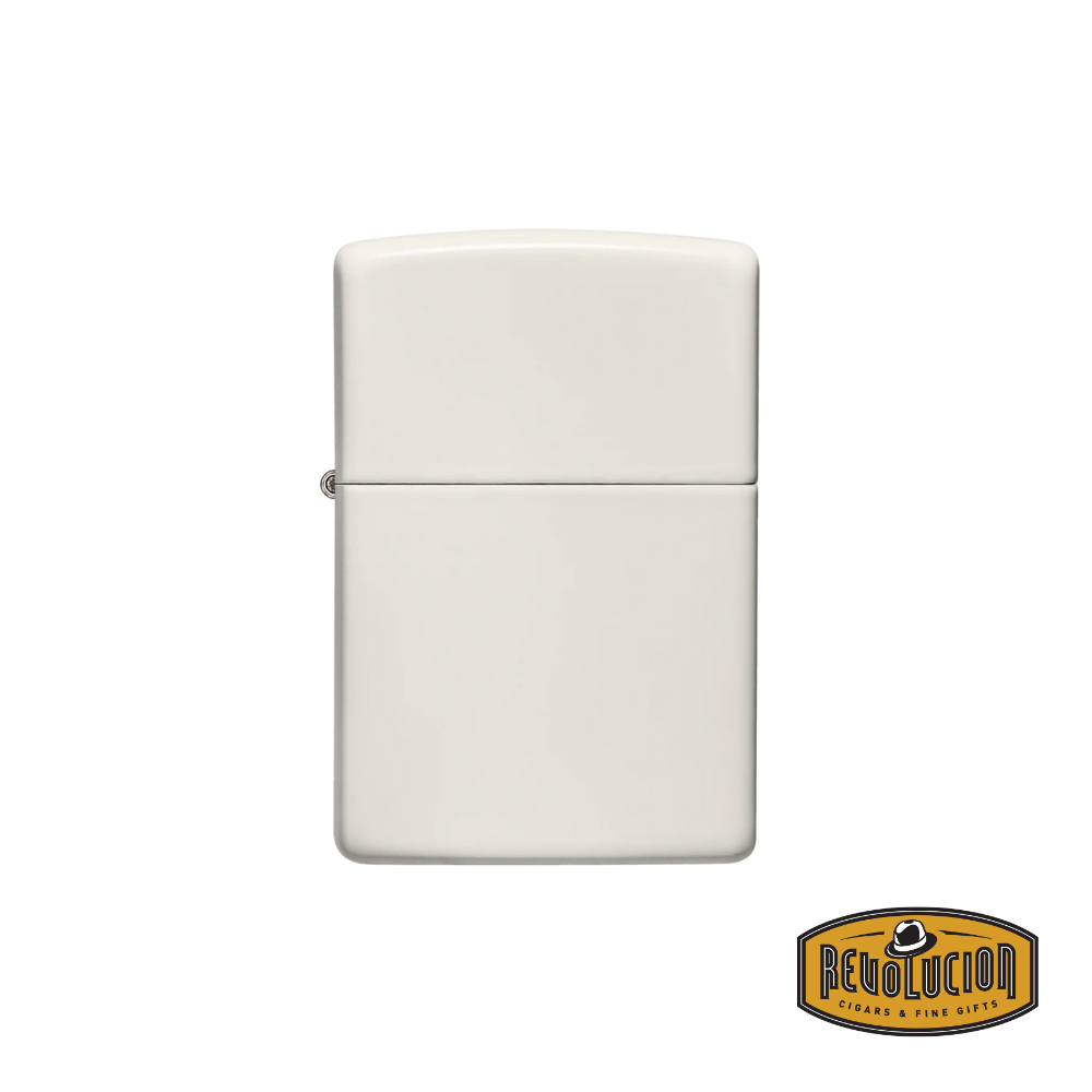 Zippo Glow In The Dark Matte lighter, closed, featuring a smooth, pale matte finish. The Revolucion Cigars & Fine Gifts logo is visible in the corner.