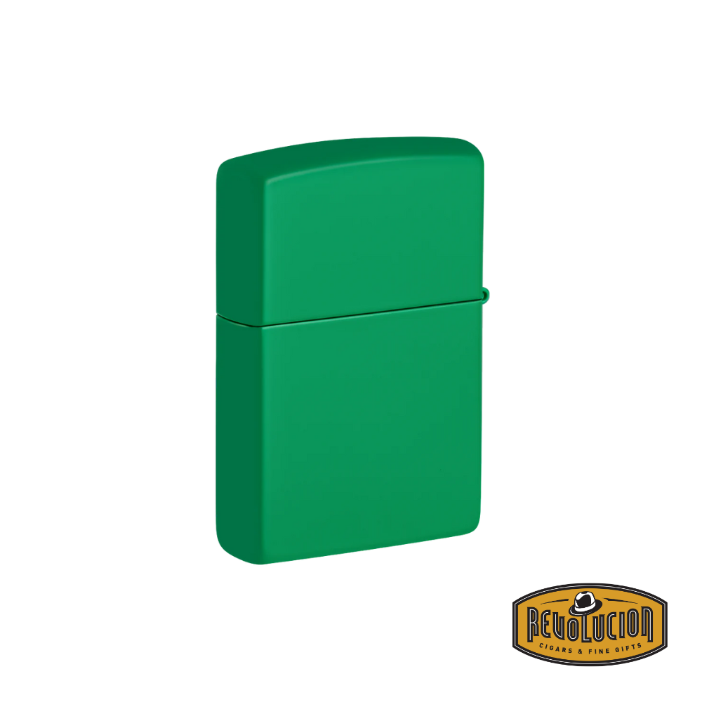 A Zippo lighter in a sleek grass green matte finish, shown closed. The smooth, minimalist design highlights its sturdy metal casing. The "Revolucion Cigars & Fine Gifts" logo appears in the bottom right corner.