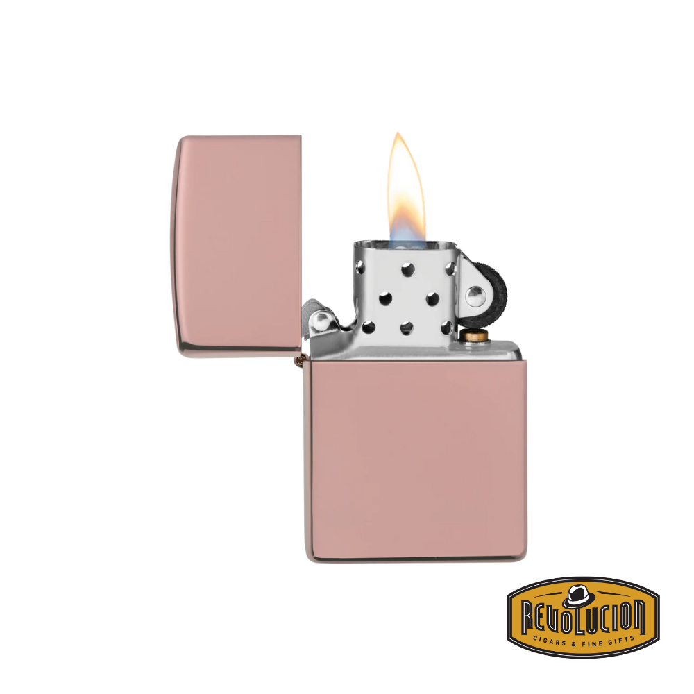 The same exquisite Zippo lighter, now opened to reveal its signature windproof ignition system. The polished rose gold finish extends to the inside, showcasing the iconic flint wheel and chimney design that Zippo is known for.