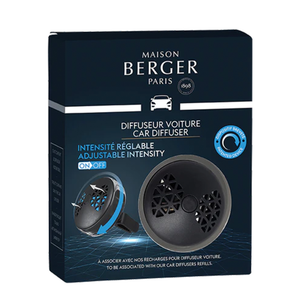 The photo shows the box of the Maison Berger Smart Car Diffuser, featuring an image of the diffuser on the front with its sleek and modern design in tones of black and gunmetal. The box is blue, includes the name of the product in white, along with its features such as the new patented system for adjusting the fragrance intensity.