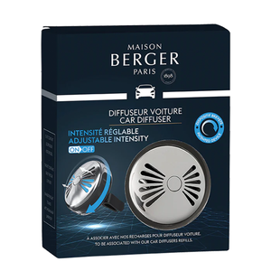 The photo shows the box of the Maison Berger Paris Flash Car Diffuser, featuring a sleek and modern design in tones of black and silver. The front of the box displays the Maison Berger Paris logo and the name of the product. 