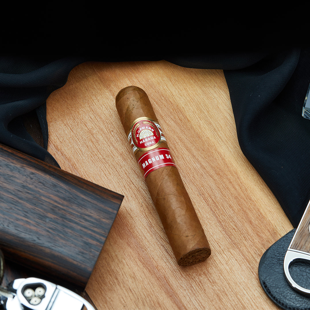 H. Upmann Magnum 54 Cuban cigar resting a wooden table
