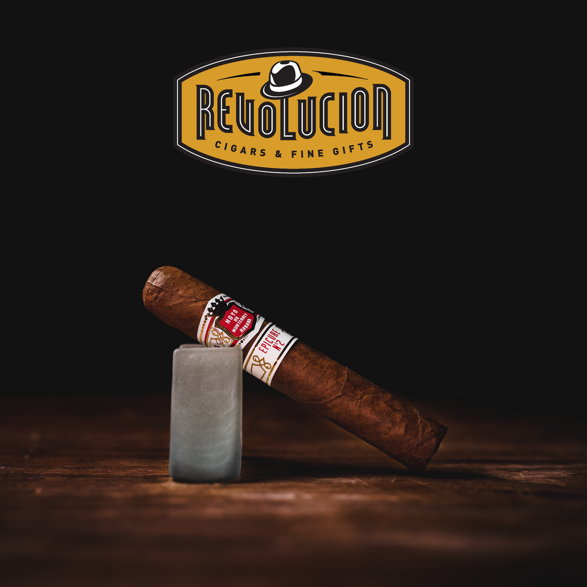 A Hoyo de Monterrey Epicure No.2 Cuban cigar displayed at an angle, showcasing its light brown wrapper, smooth texture, and elegant red-and-white band.