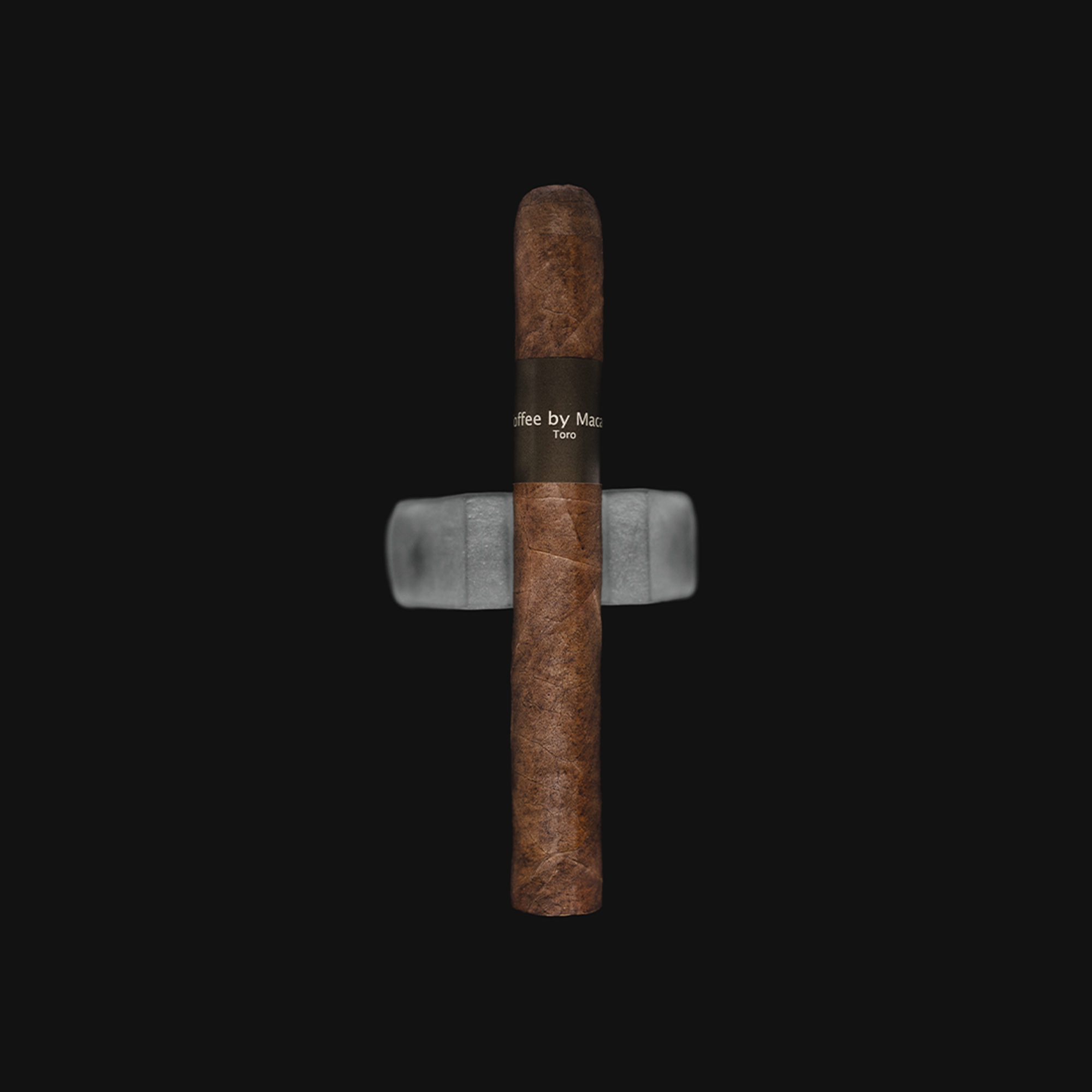 Macanudo M Coffee Toro Mild-Medium Strength Nicaraguan Cigars on a white background with the Revolucion logo, featuring its sleek toro shape and oily, coffee-infused wrapper.