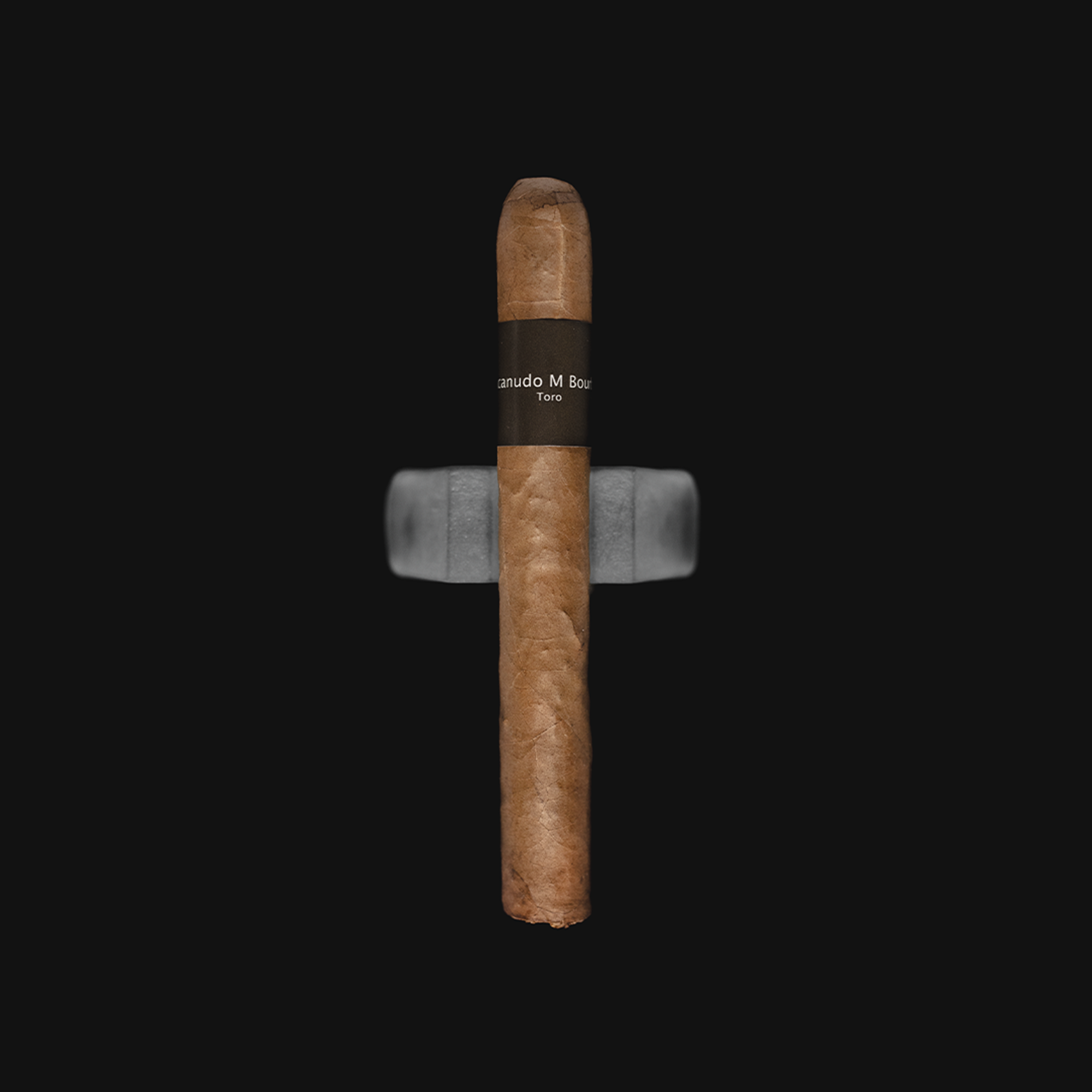 Macanudo Bourbon Toro Mild-Medium Strength Nicaraguan Cigars placed on a white background with the Revolucion logo, highlighting its smooth wrapper and elegant band design.
