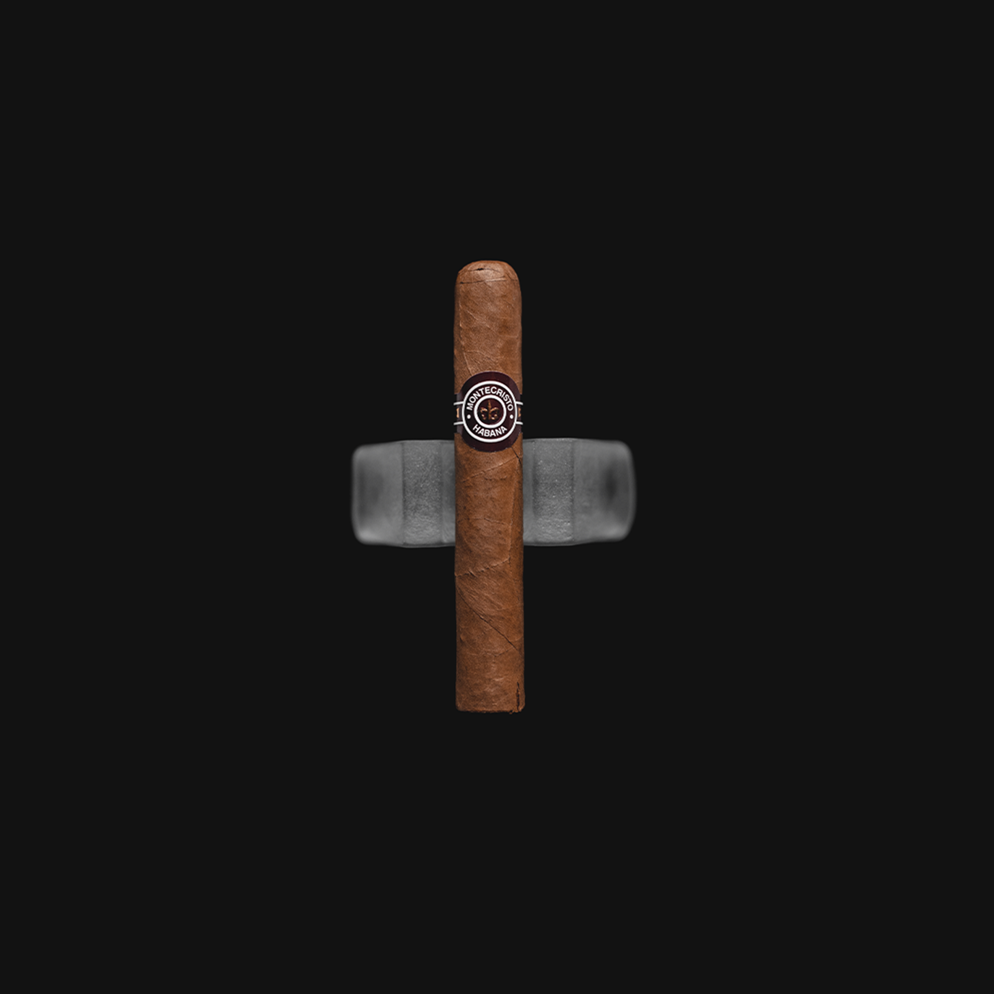 Montecristo No.5 Cuban Cigar - Front View: A compact Montecristo No.5 cigar with a smooth brown wrapper and the classic Montecristo band, highlighting its premium craftsmanship.