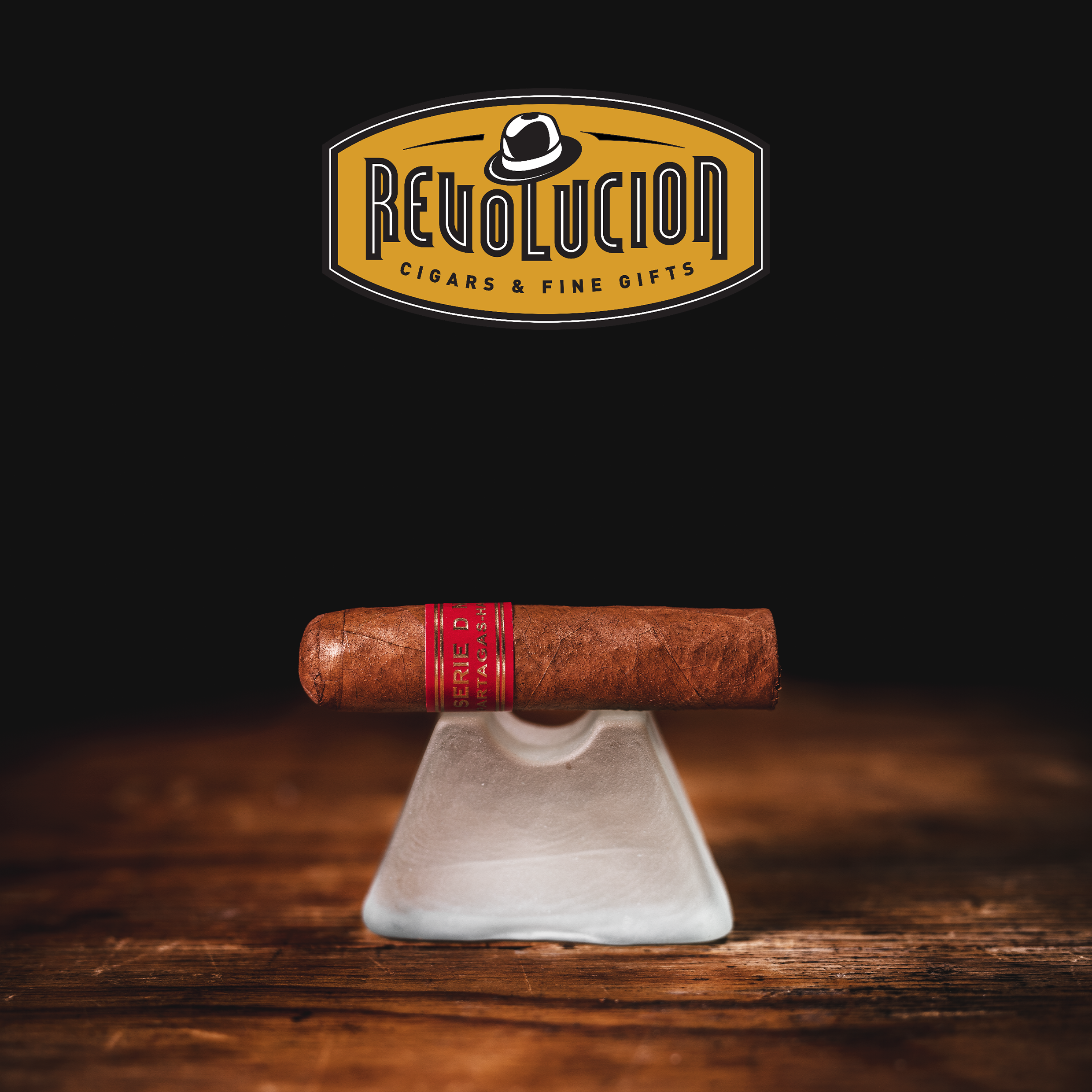 Partagás Serie D No. 6 Cuban cigar with a red band, placed on a Glass object with a dark background.