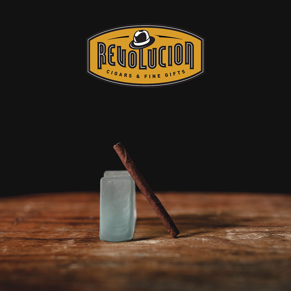 A Partagás Series Mini Cuban cigarillo positioned at an angle, showing its wrapper and construction.