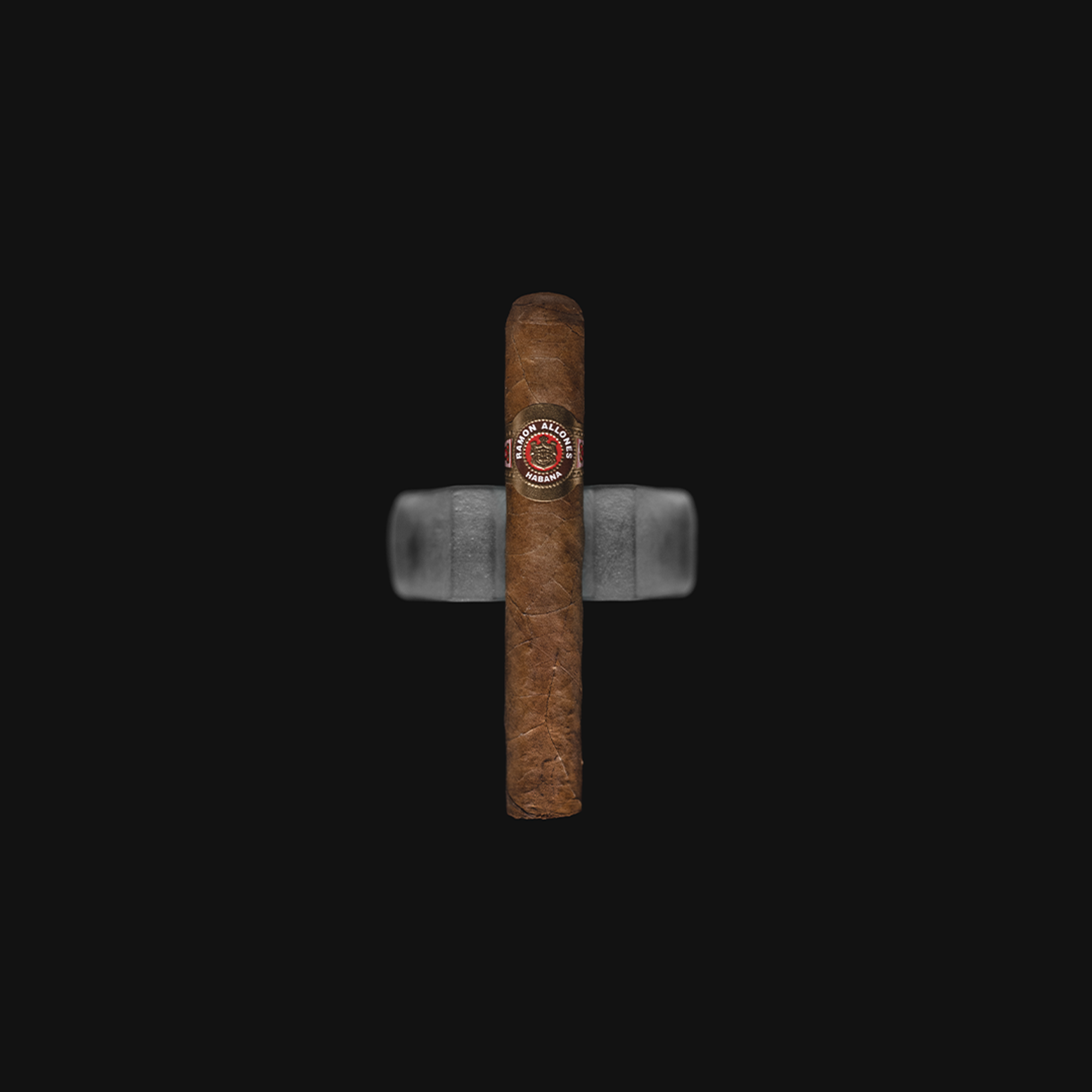 Ramon Allones Small Club Coronas – a medium-strength Cuban cigar in a petite corona format, featuring a dark, oily wrapper and the signature green, gold, and red Ramon Allones band.
