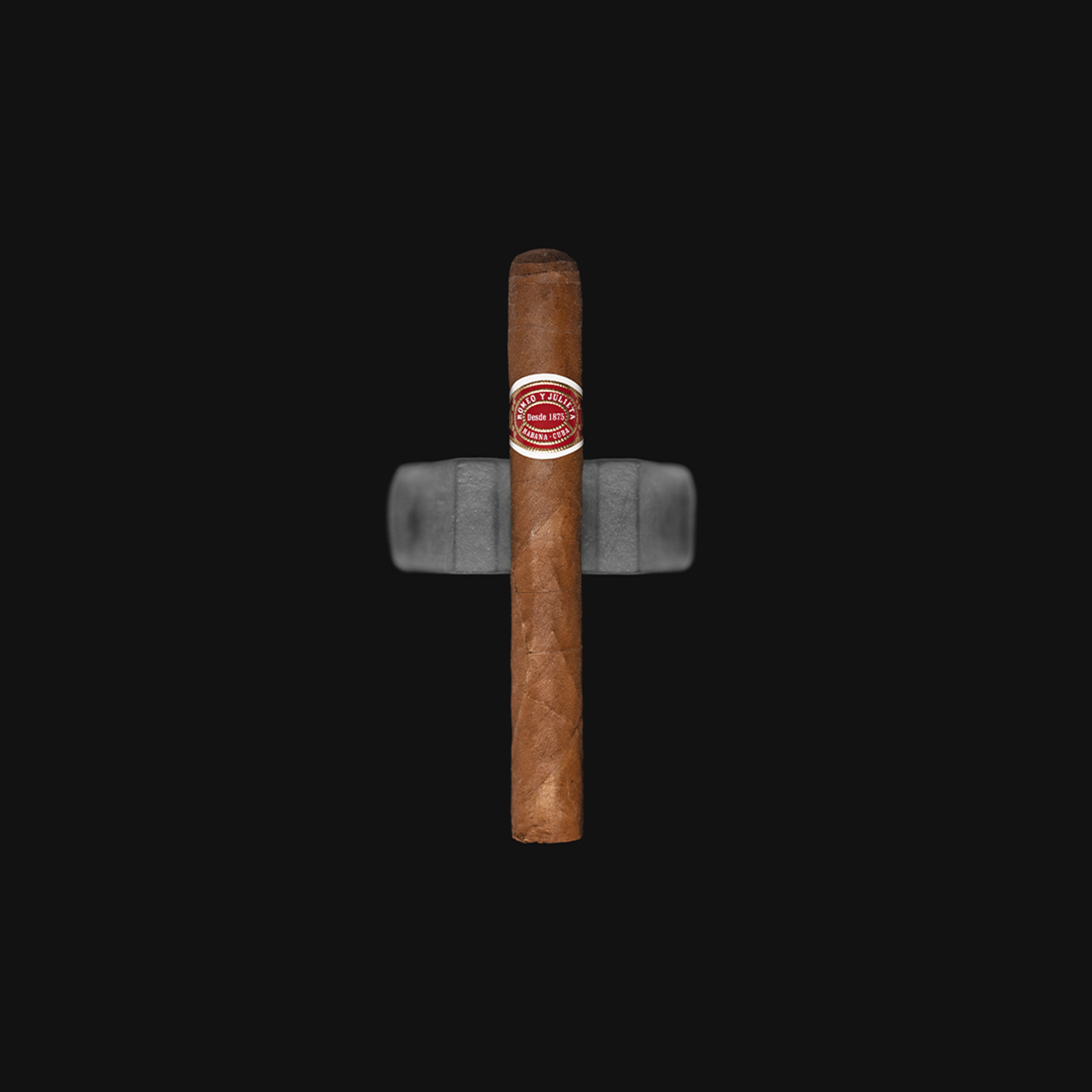 Romeo y Julieta No. 2 Cuban cigar resting on a dark background, showcasing its iconic red and white band.